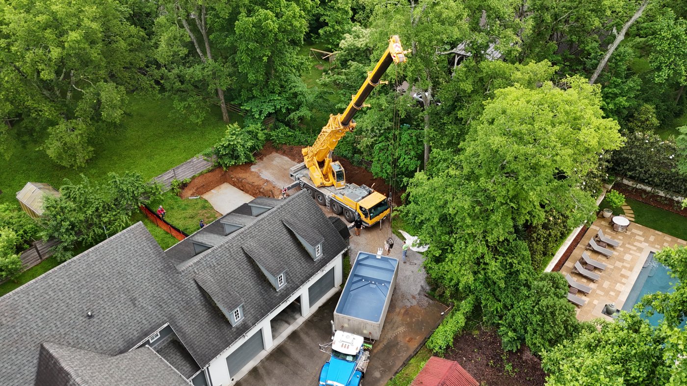 Precast concrete plunge pool being craned into place